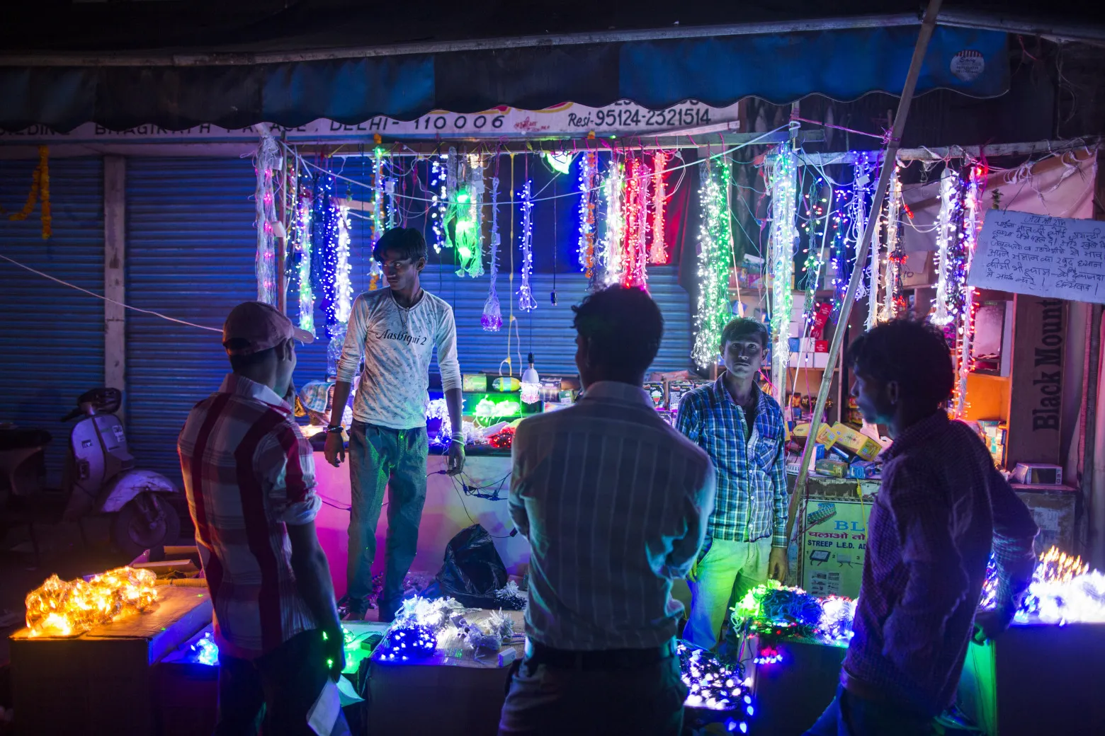 People shop for lights in a wholesale market during Diwali celebrations in Delhi, India.