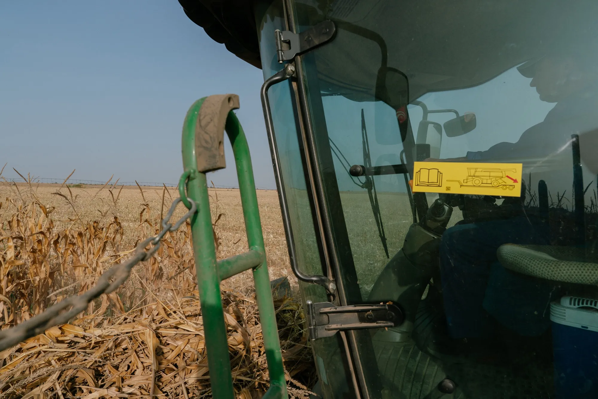 A farmer operates a forage harvester to cut corn plants in a field in Galati, Romania, a year ago.