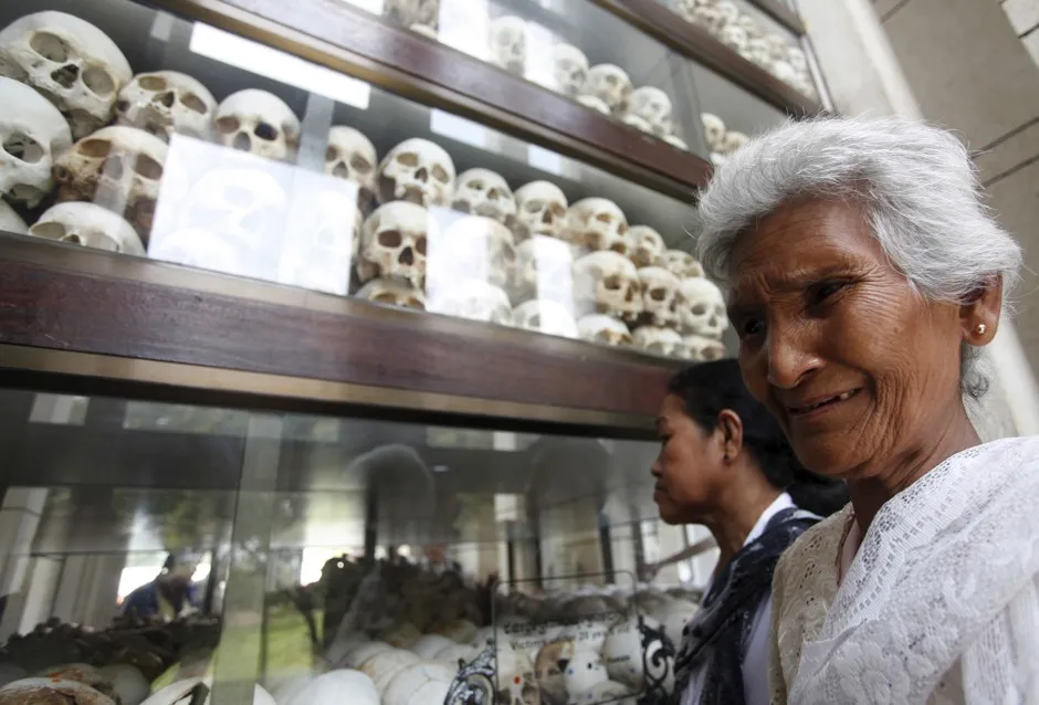 A woman cries in front of the remains of more than 8,000 victims of the Khmer Rouge.
