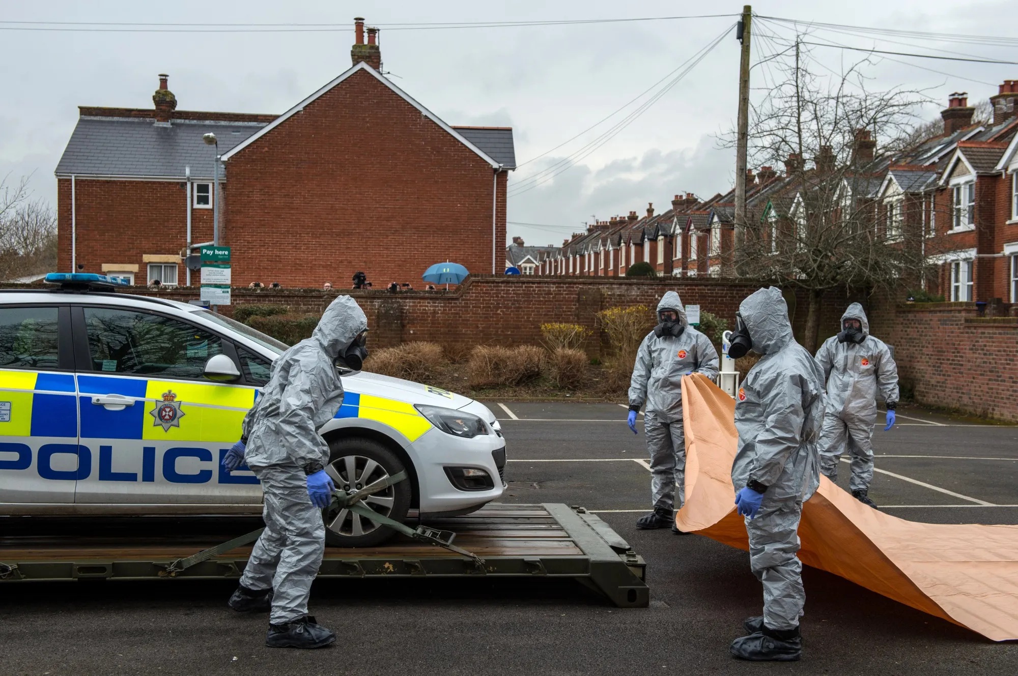 Authorized personnel remove a police car from a public park during Skripal poisoning investigations in March 2018.