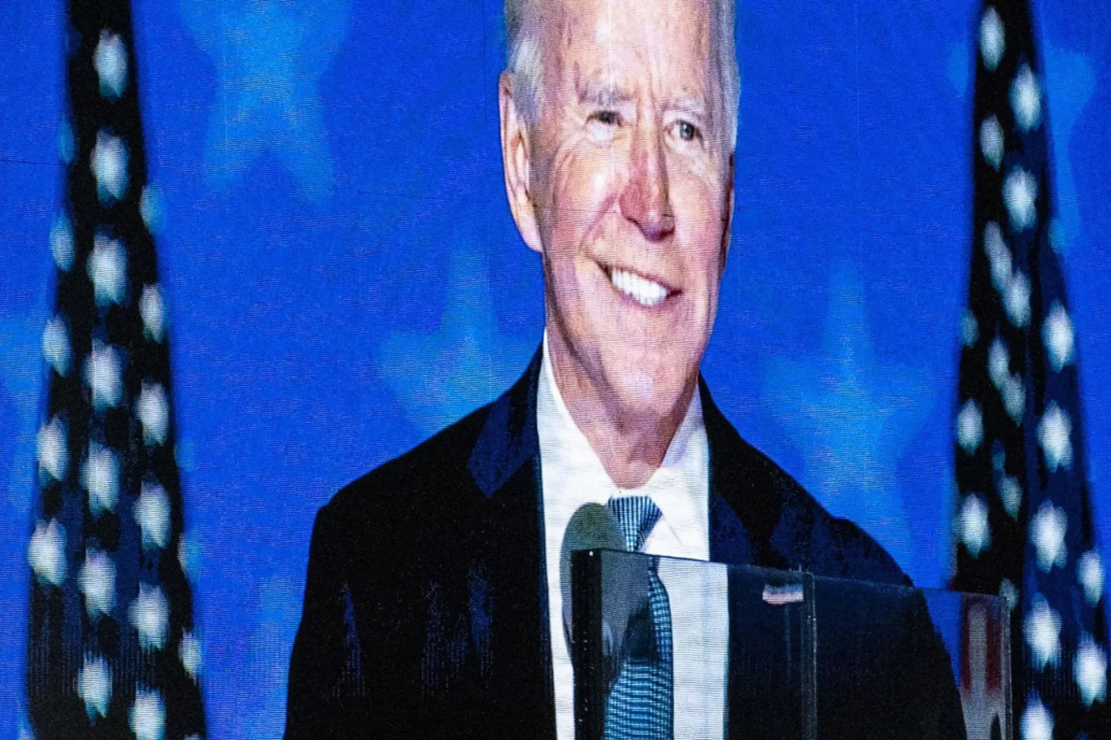 President-elect Joe Biden is displayed on a screen while speaking during an election night party in Wilmington, Del., on Nov. 4.