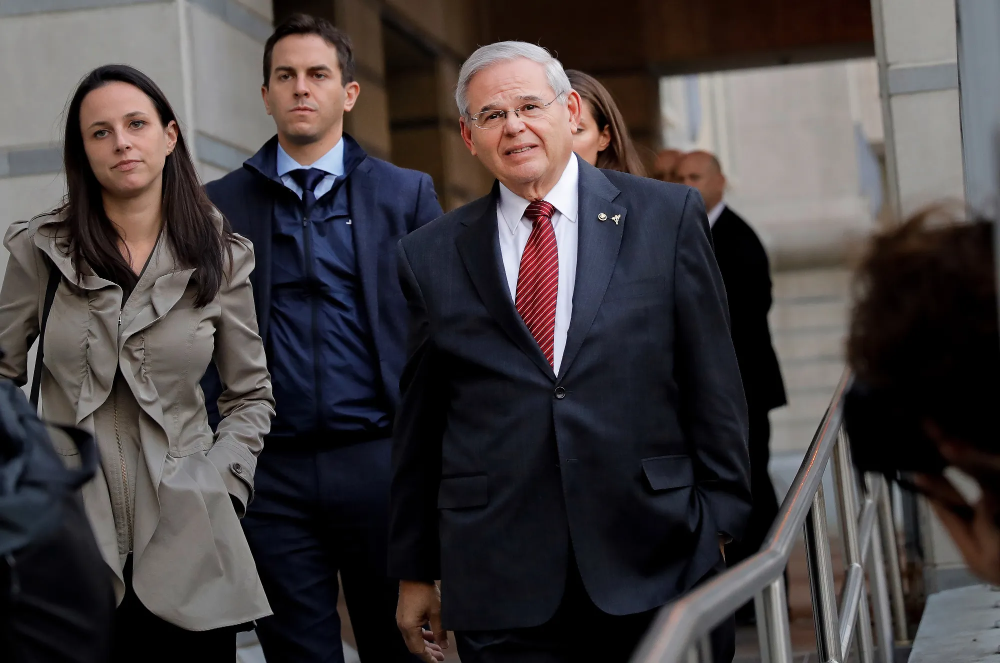 Senator Robert Menendez, a Democrat from New Jersey, right, exits federal court in Newark, New Jersey, on Nov. 9, 2017.&nbsp;