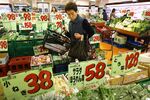 A customer browses vegetables at a supermarket in Tokyo, Japan on  April 9