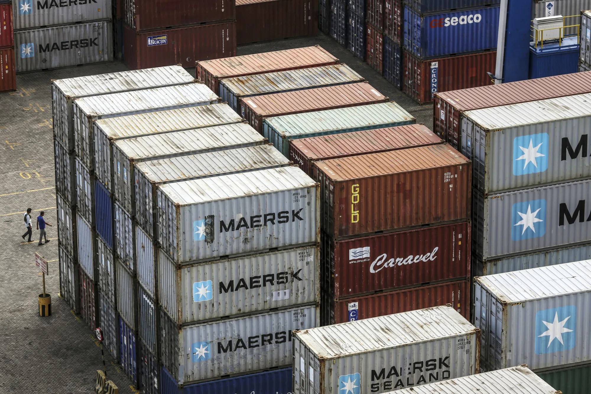 Containers sit stacked in a yard at Krishnapatnam Port in Krishnapatnam, Andhra Pradesh, India, on Saturday, Aug. 12, 2017. Growth in gross domestic product slipped to a three-year low in the April-June quarter, muddying the near-term outlook, though the goods and services tax, or GST, is expected to boost productivity in the longer term.