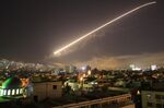 The Damascus sky lights up missile fire as the U.S. launches an attack on Syria targeting different parts of the capital early Saturday, April 14, 2018.