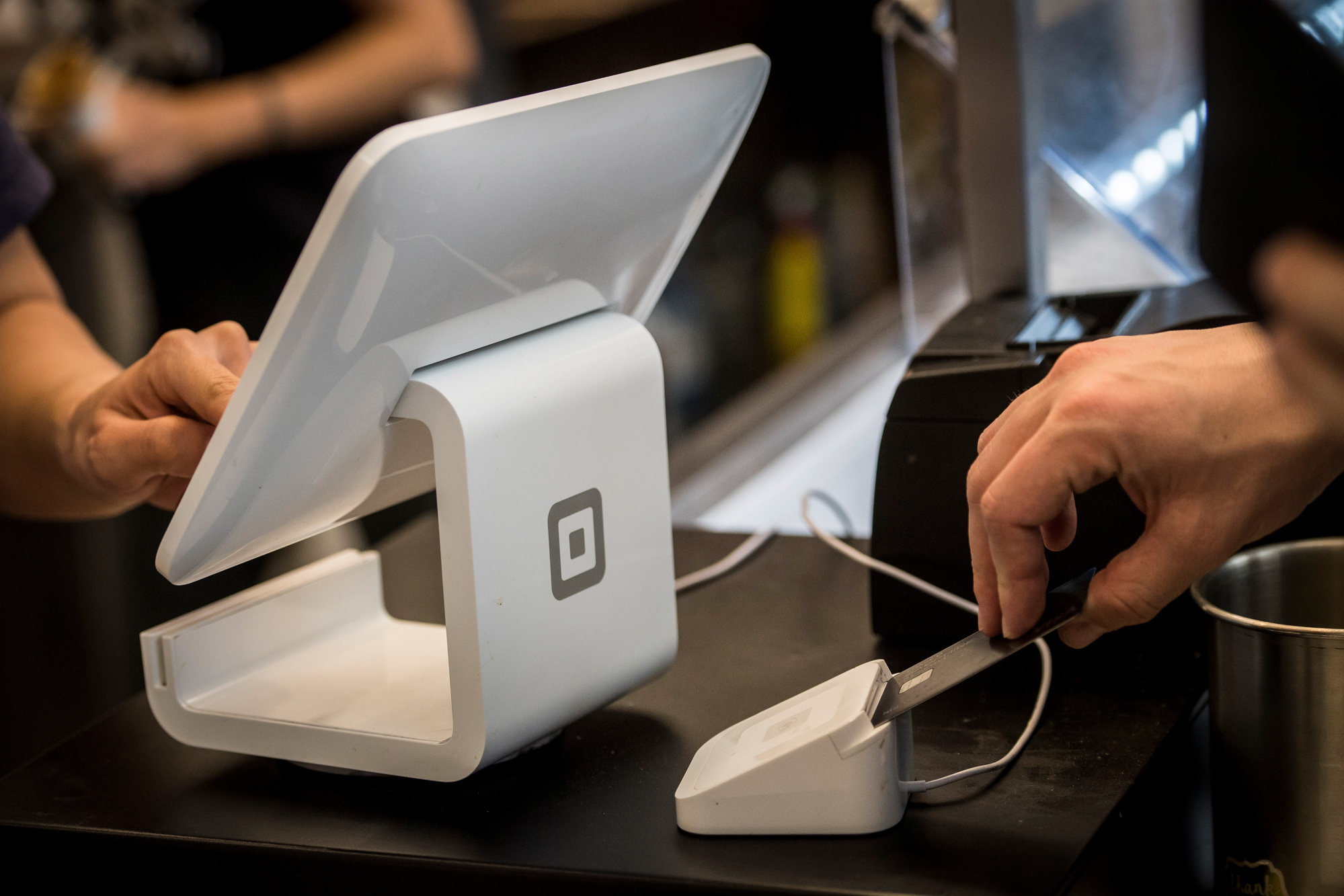 A customer inserts a credit card into Square&nbsp;device while making a payment in San Francisco.