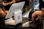 A customer inserts a credit card into Square device while making a payment in San Francisco.