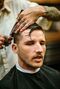 Kevin Douglas is the founder and moderator of the sub-group Bunz Home Zone, seen here at getting free haircut courtesy of Bunz. The barber is apprenticing and puts up a free haircut on Bunz every day, estimating that 60% of his current clients are from Bunz connections.