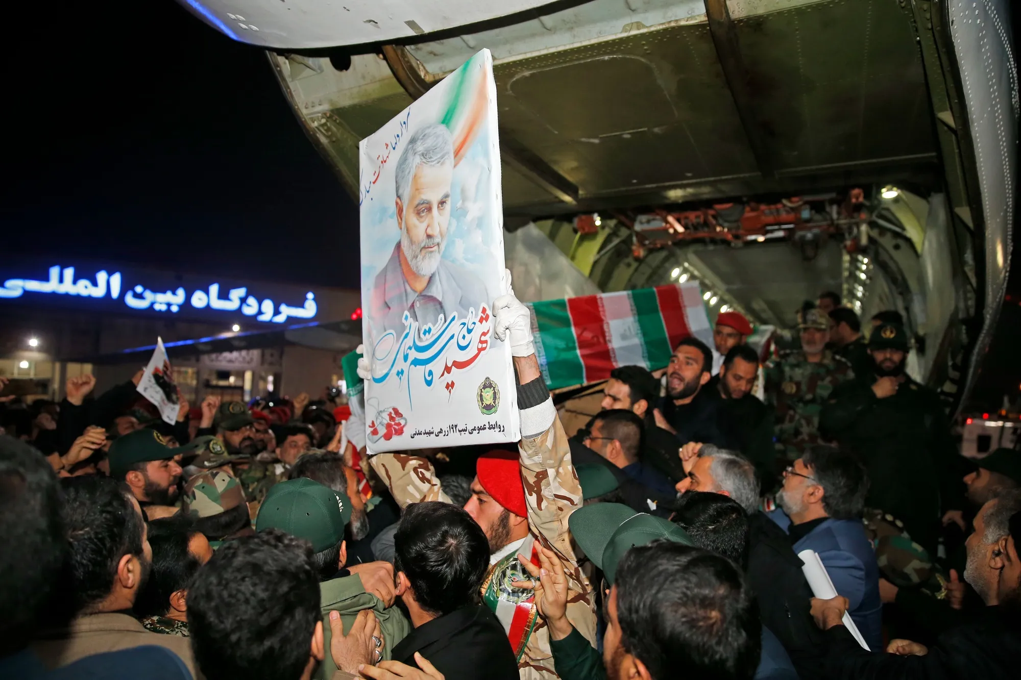 People carry the casket of Qasem Soleimani upon arrival at Ahvaz International Airport in southwestern Iran on Jan. 5.