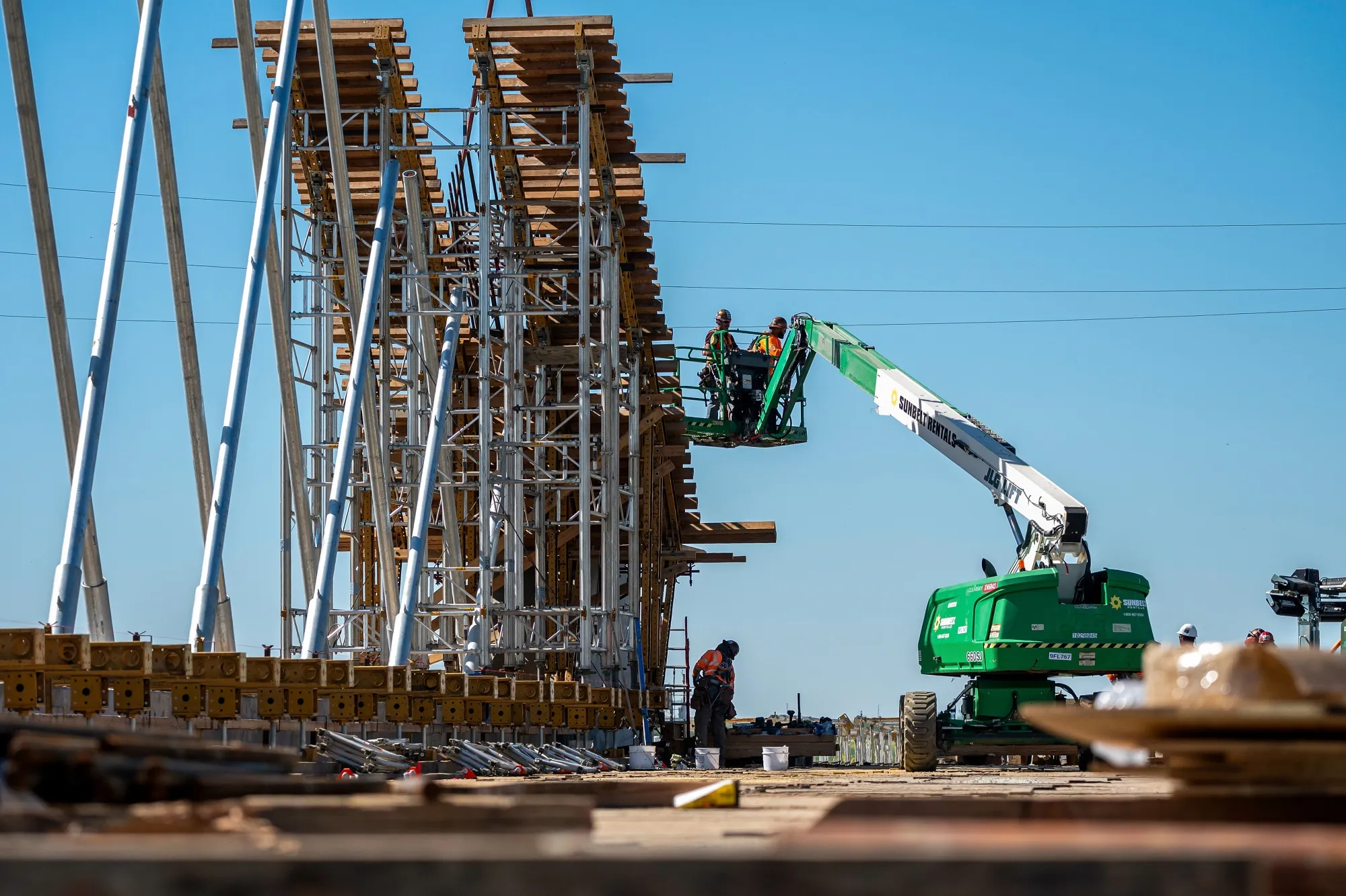 Contractors on a cherry picker during the construction of a high-speed rail project in Kings County, California, on March 24.