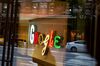 Pedestrians are reflected in a window looking into a lobby of the Google Inc. offices in New York.