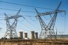 Electrical power lines hang from transmission pylons as the Eskom Holdings SOC Ltd. Hendrina coal-fired power station stands beyond in the town of Pullen's Hope, Mpumalanga, South Africa.