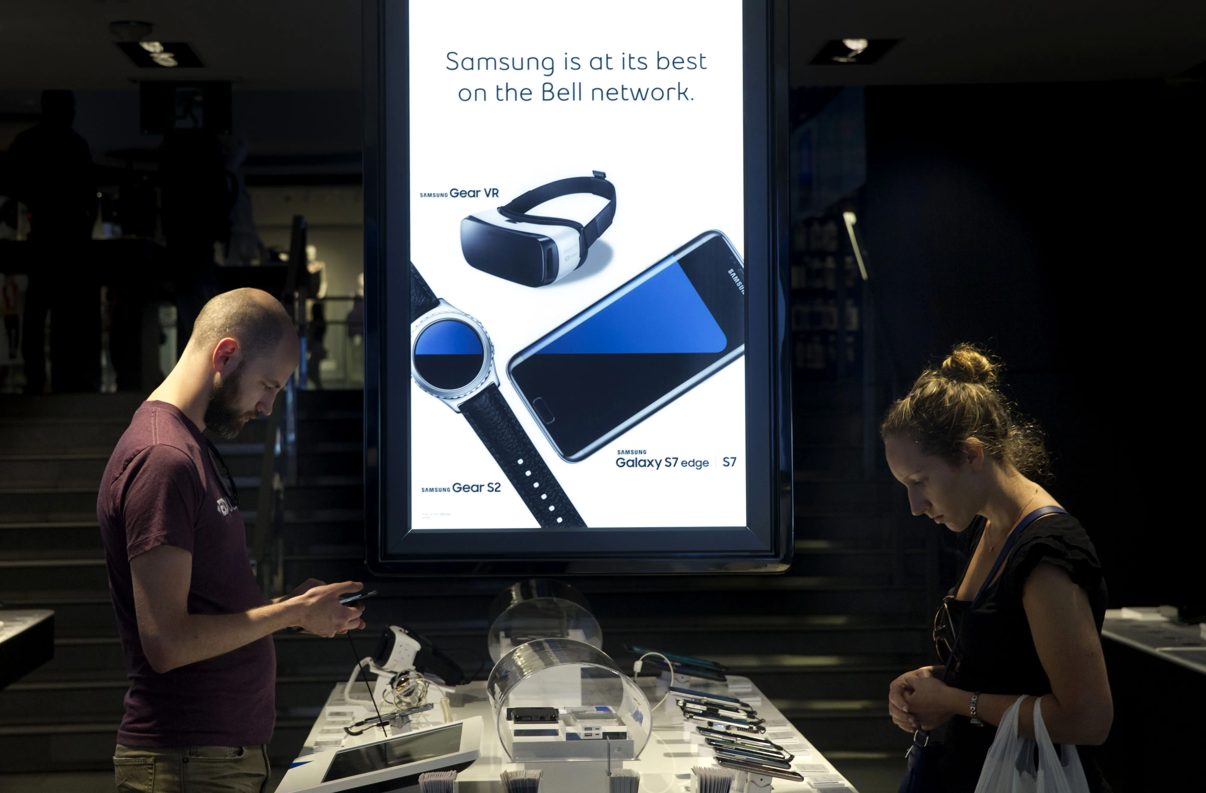 Customers browse mobile phones at a Bell Canada store in Toronto, Ontario, Canada.