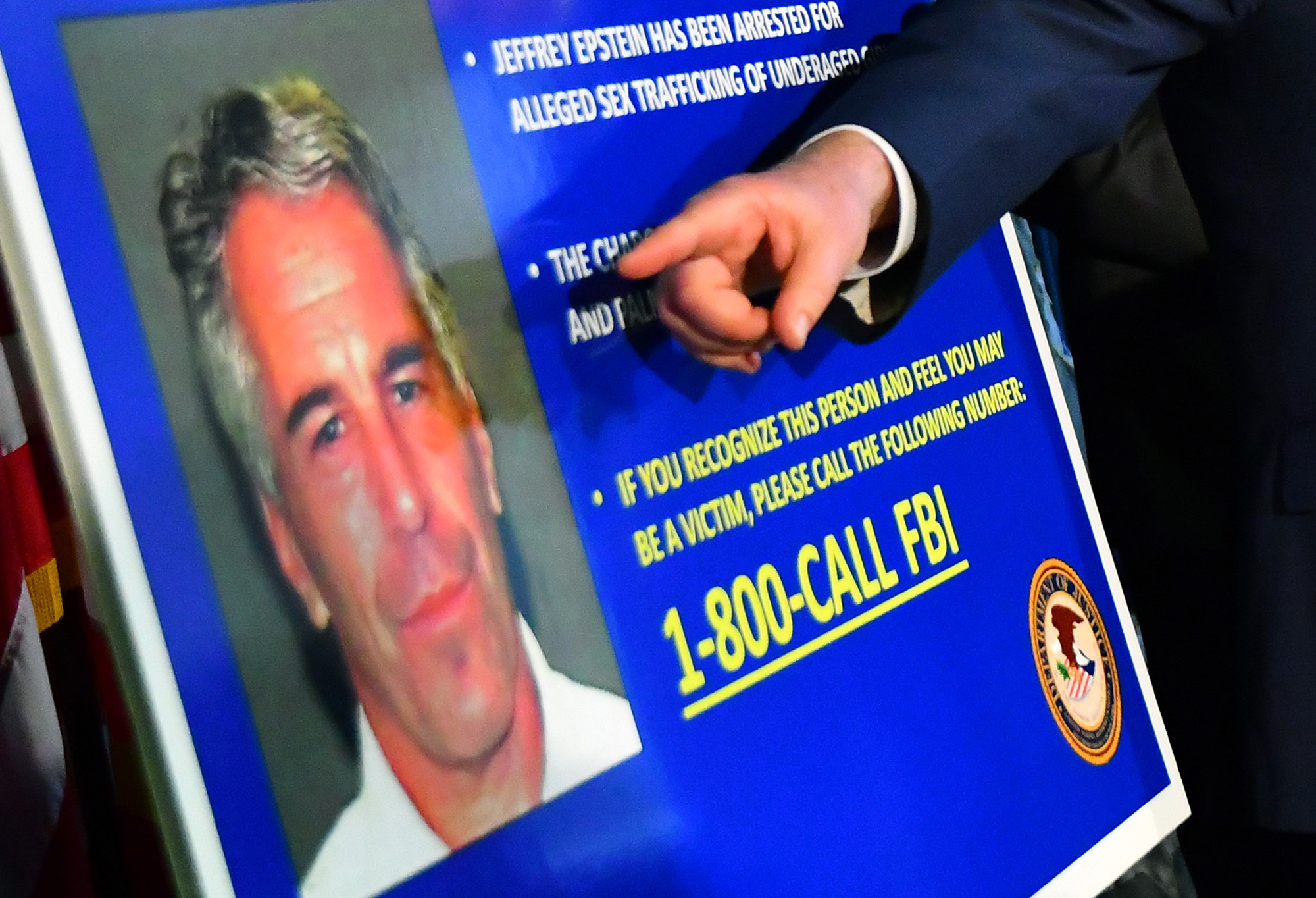 Geoffrey Berman, U.S. attorney for the Southern District of New York, speaks while standing next to a poster displaying the image of fund manager Jeffrey Epstein during a news conference in New York, U.S., on Monday, July 8, 2019. Photographer: Louis Lanzano/Bloomberg