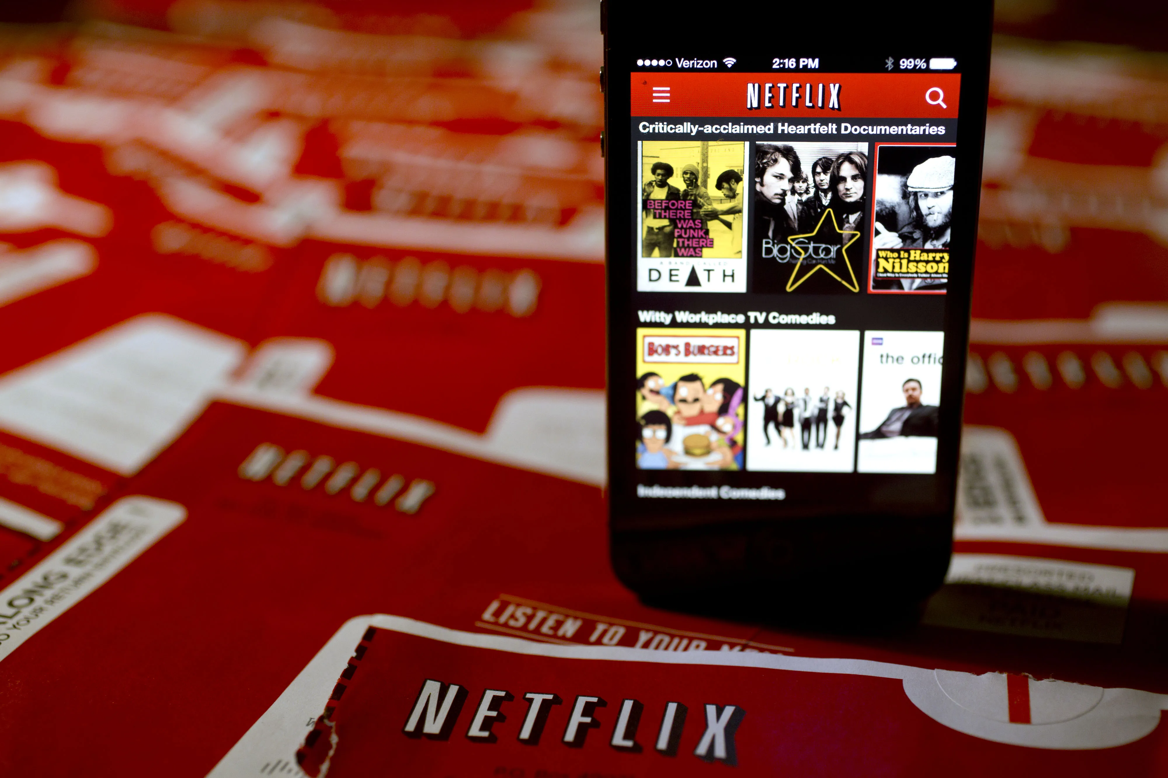As Comcast builds a moat around its subscribers, Netflix is paying to get in. Photographer: Andrew Harrer/Bloomberg