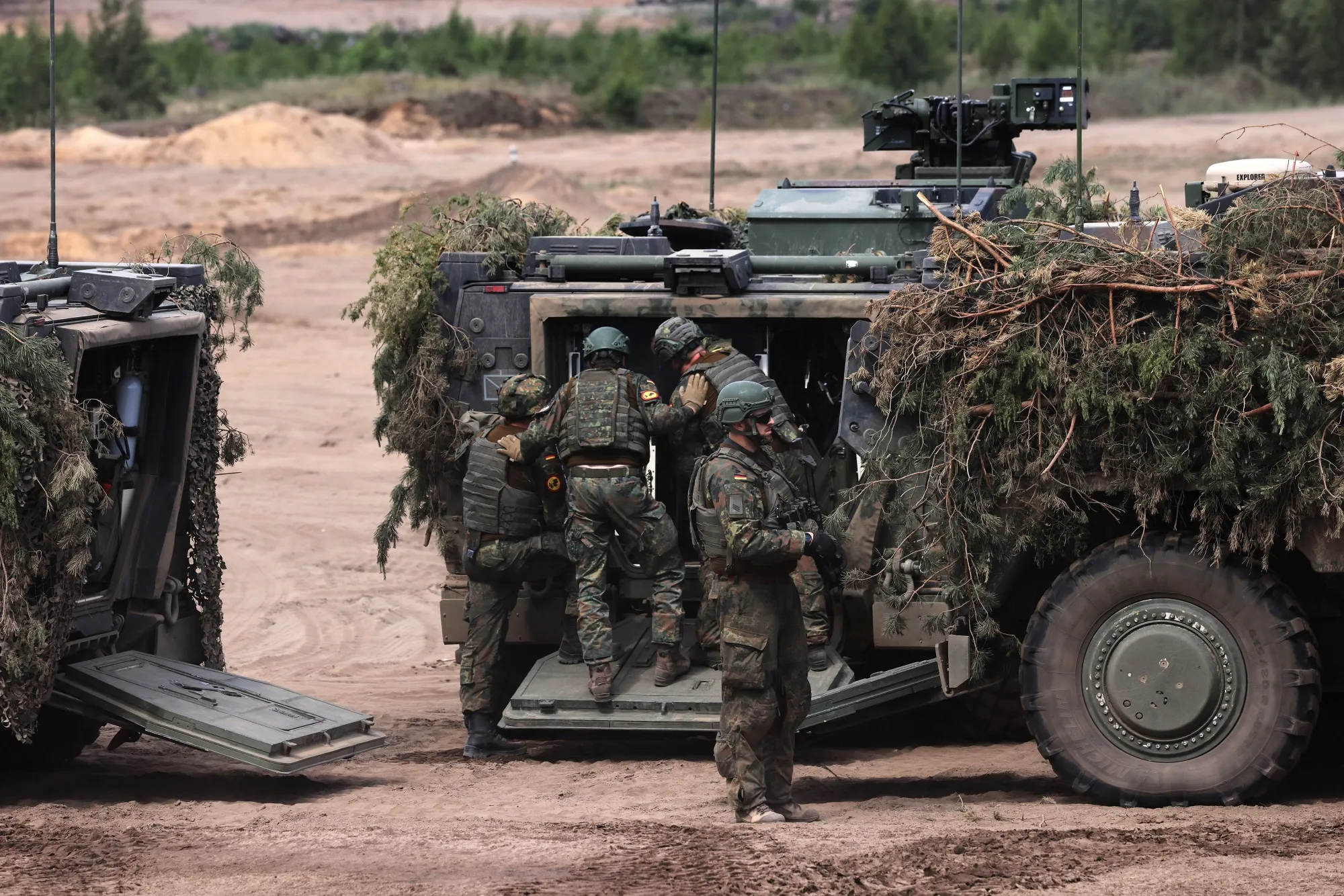 German soldiers enter an armored vehicle during a NATO&nbsp;military exercise&nbsp;in Lithuania, in May.
