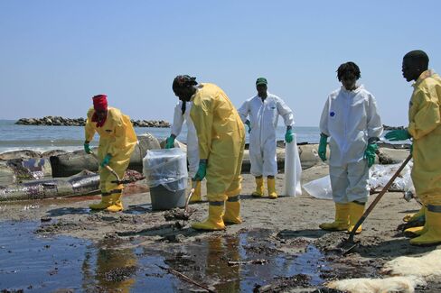 A BP cleanup crew shovels oil from a Louisiana beach on May 2010.