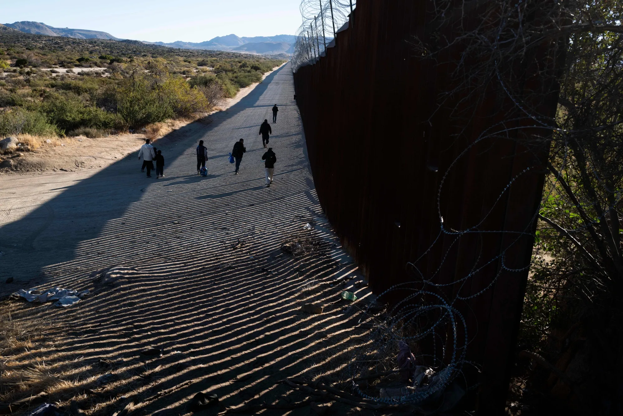 Migrants after entering the United States through a gap in the border wall in Jacumba Hot Springs, California, in November.&nbsp;