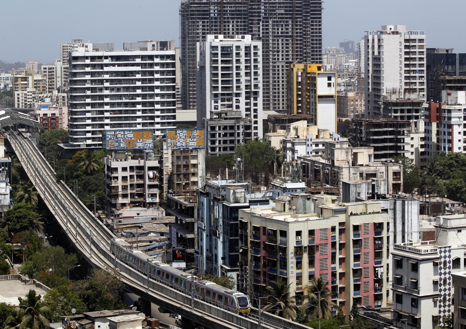 Mumbai's metro passes through a dense residential area.