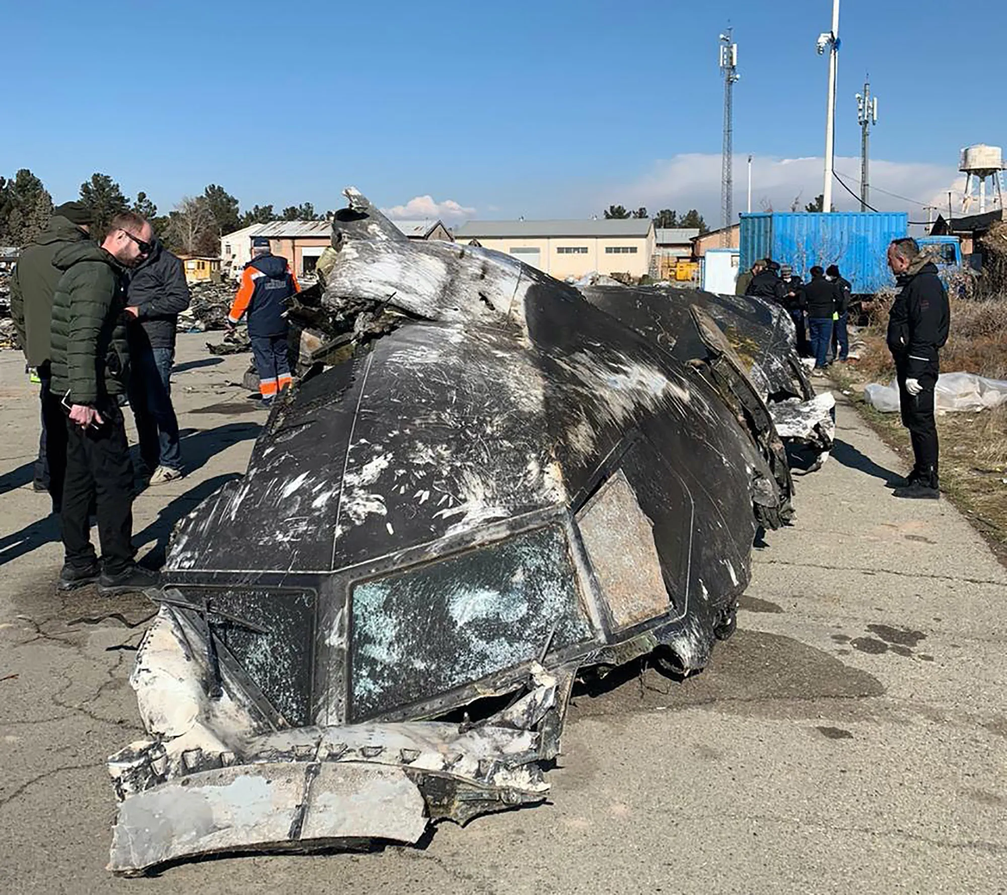 A section of fuselage from Ukraine International Airlines Flight 752 is inspected by Ukrainian investigators.