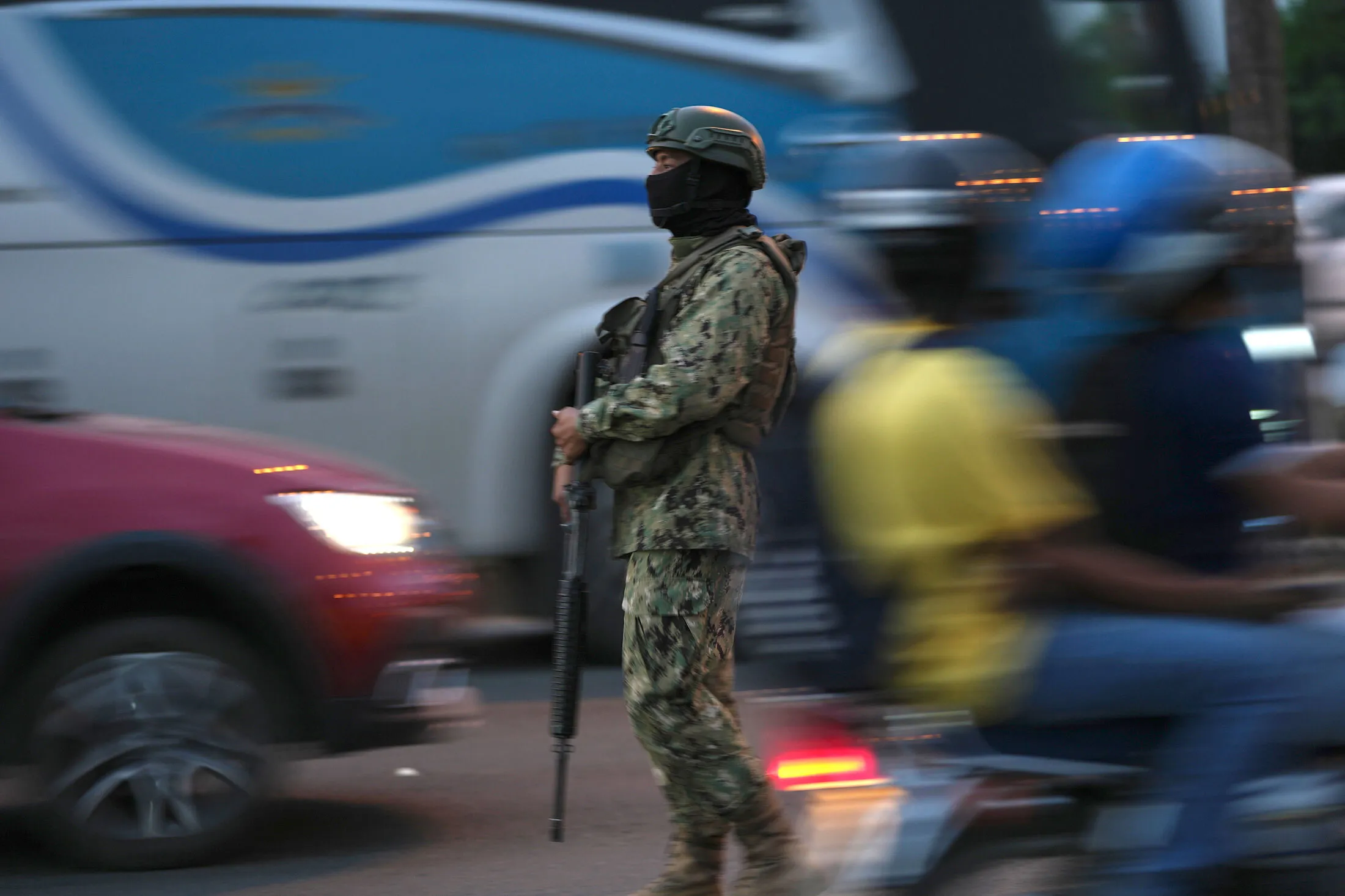 A soldier patrols a bridge that connects the increasingly dangerous cities of Durán and Guayaquil.