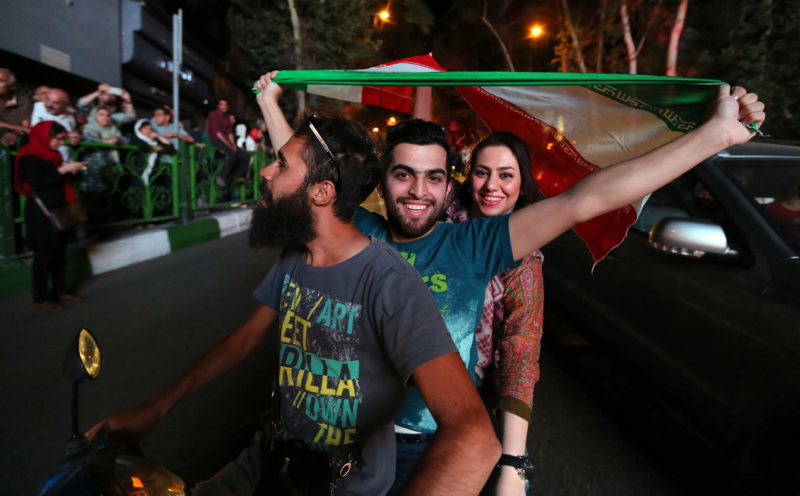 Iranians wave the national flag during celebrations in Tehran on Tuesday, July 14. Photographer: Atta Kenare/AFP via Getty Images
