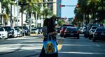 A woman wears a mask as she walks in Miami Beach, Florida on July 2, 2020. 