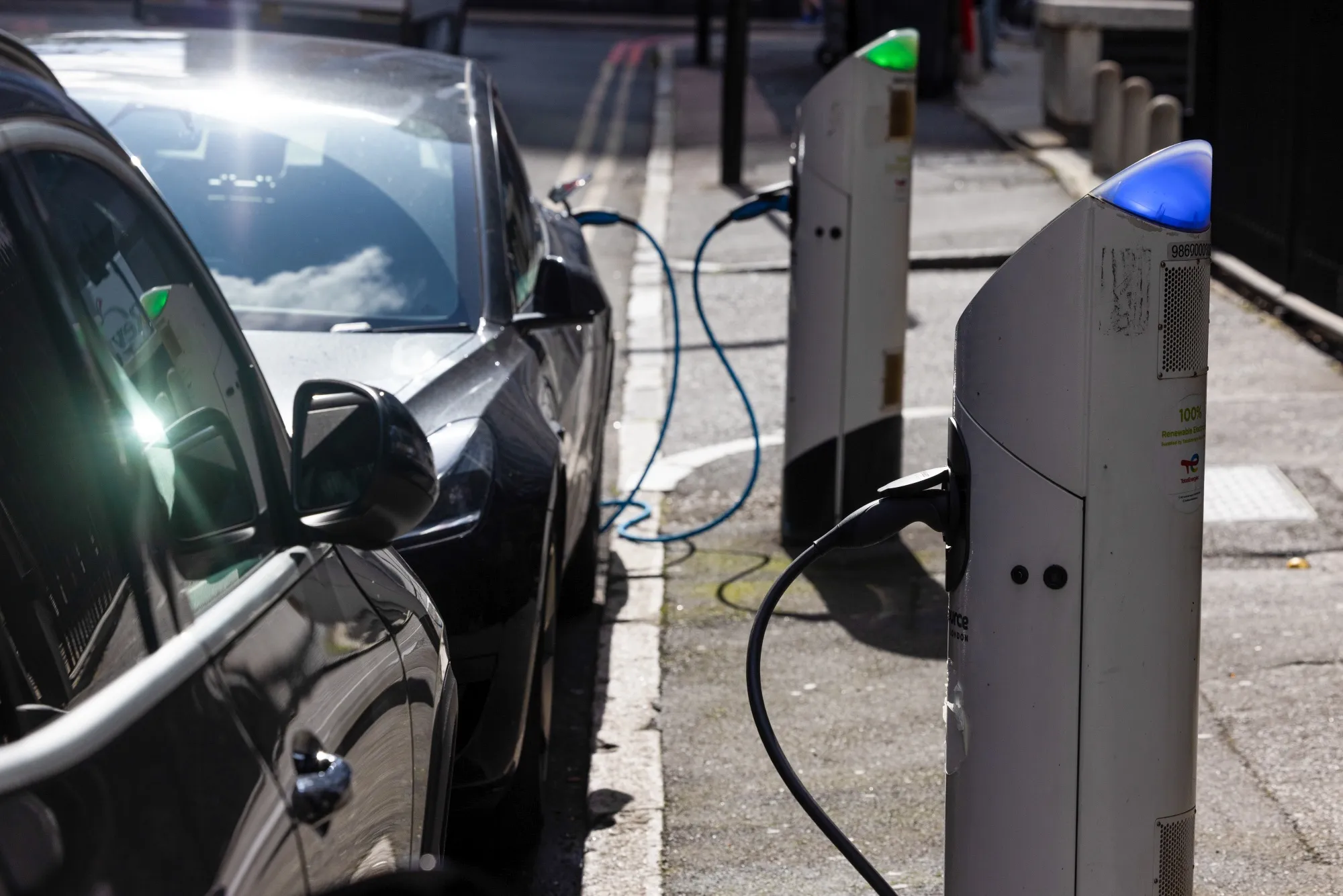 Electric vehicles plugged in at a charging point in London, UK.