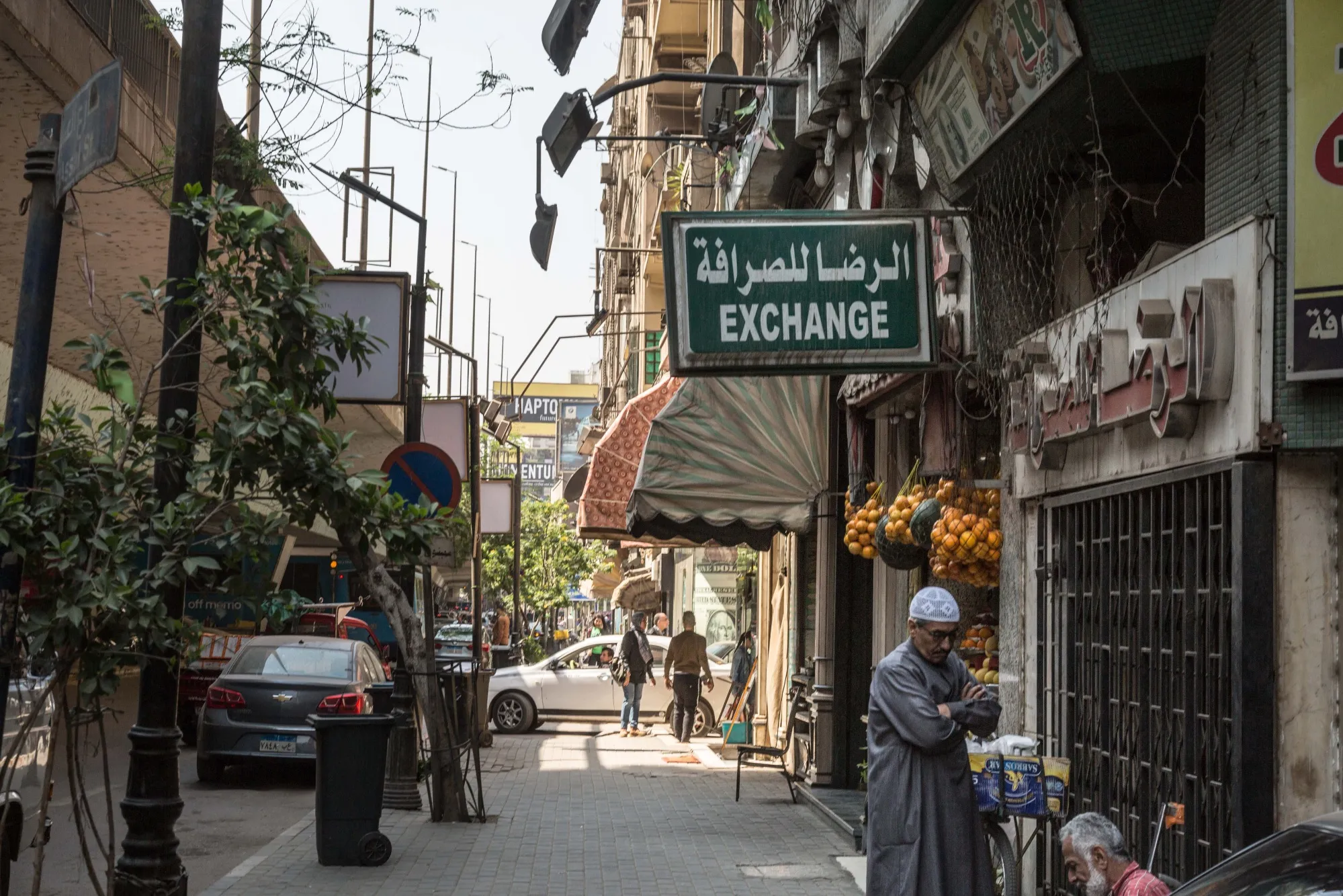 A pedestrian stands by a currency exchange bureau in Cairo.