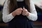 A student opens a Covid-19 test swab at an elementary school in Boston.