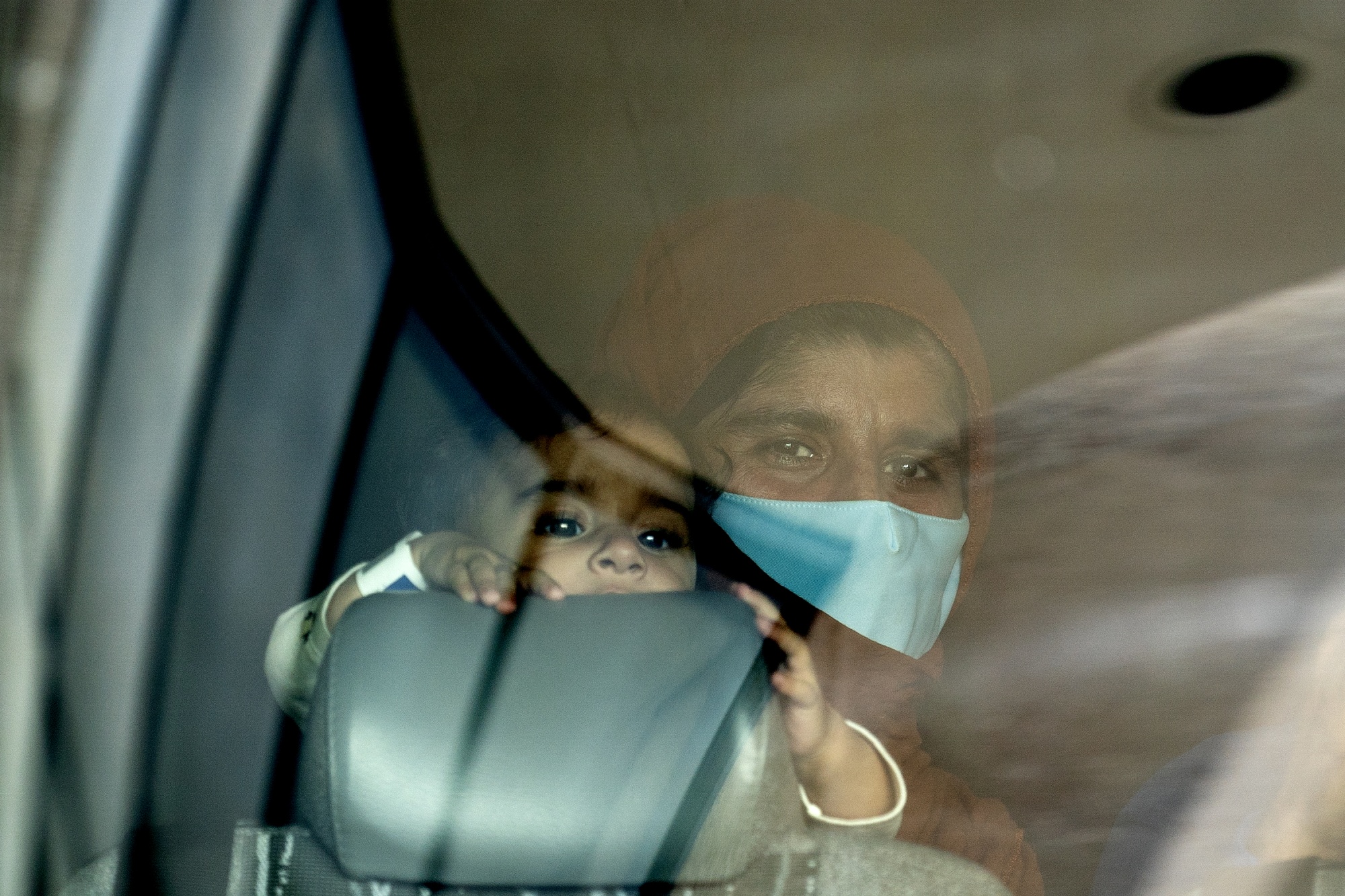 A refugee from Afghanistan holds a baby on a bus after arriving at Washington Dulles International Airport in Dulles, Virginia,&nbsp;on&nbsp;Aug. 31.