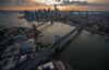 The Brooklyn Bridge, left, and Manhattan Bridge stand at dusk in this aerial photograph taken above New York, U.S., on Friday, June 19, 2015. The Standard & Poor's 500 Index fell, with the gauge dropping below its price for the past 50 days, while Treasuries retreated.