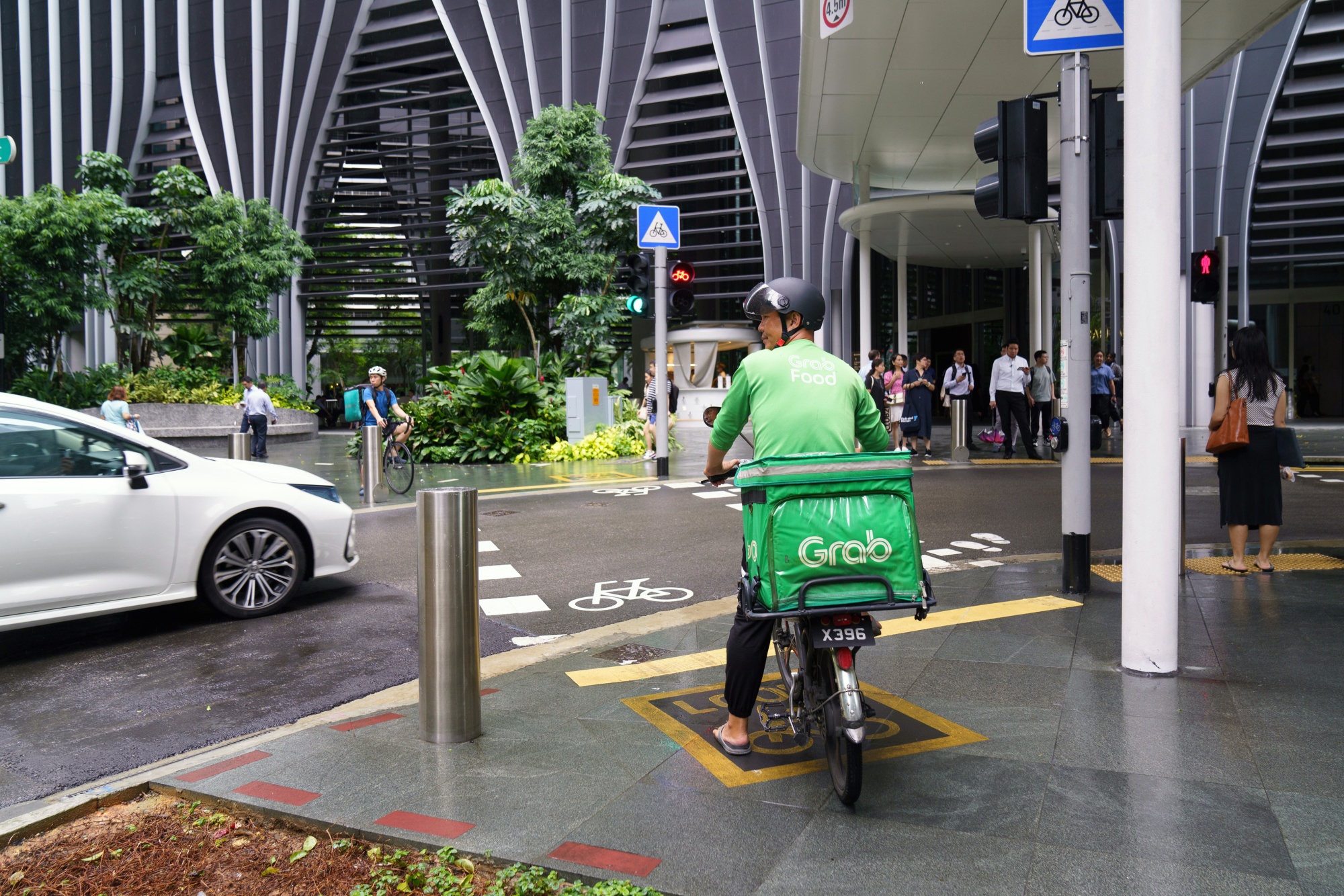 A Grab food delivery cyclist makes a delivery in Singapore.