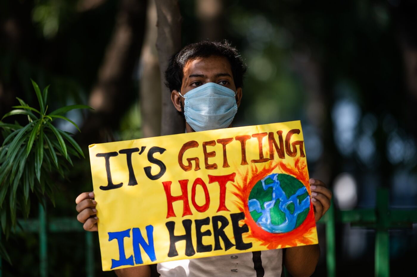 A protestor in India protesting for climate change and advocating for renewable energy.