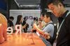 Attendees look at smartphones displayed at the Oppo booth at the MWC Shanghai exhibition in Shanghai, China, on Thursday, June 27, 2019.