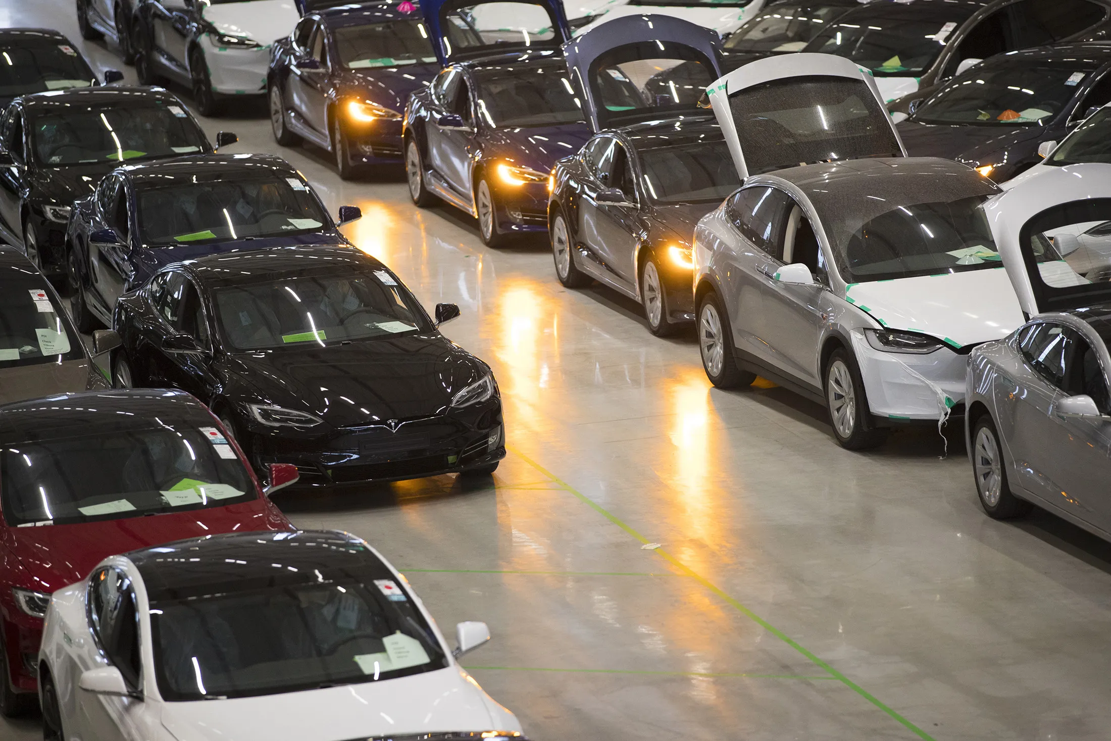 A new Tesla Model X sports utility vehicle (SUV), second right, sits with Tesla Model S automobiles following assembly for the European market at the Tesla Motors Inc. factory in Tilburg, Netherlands, on Dec. 9, 2016.
