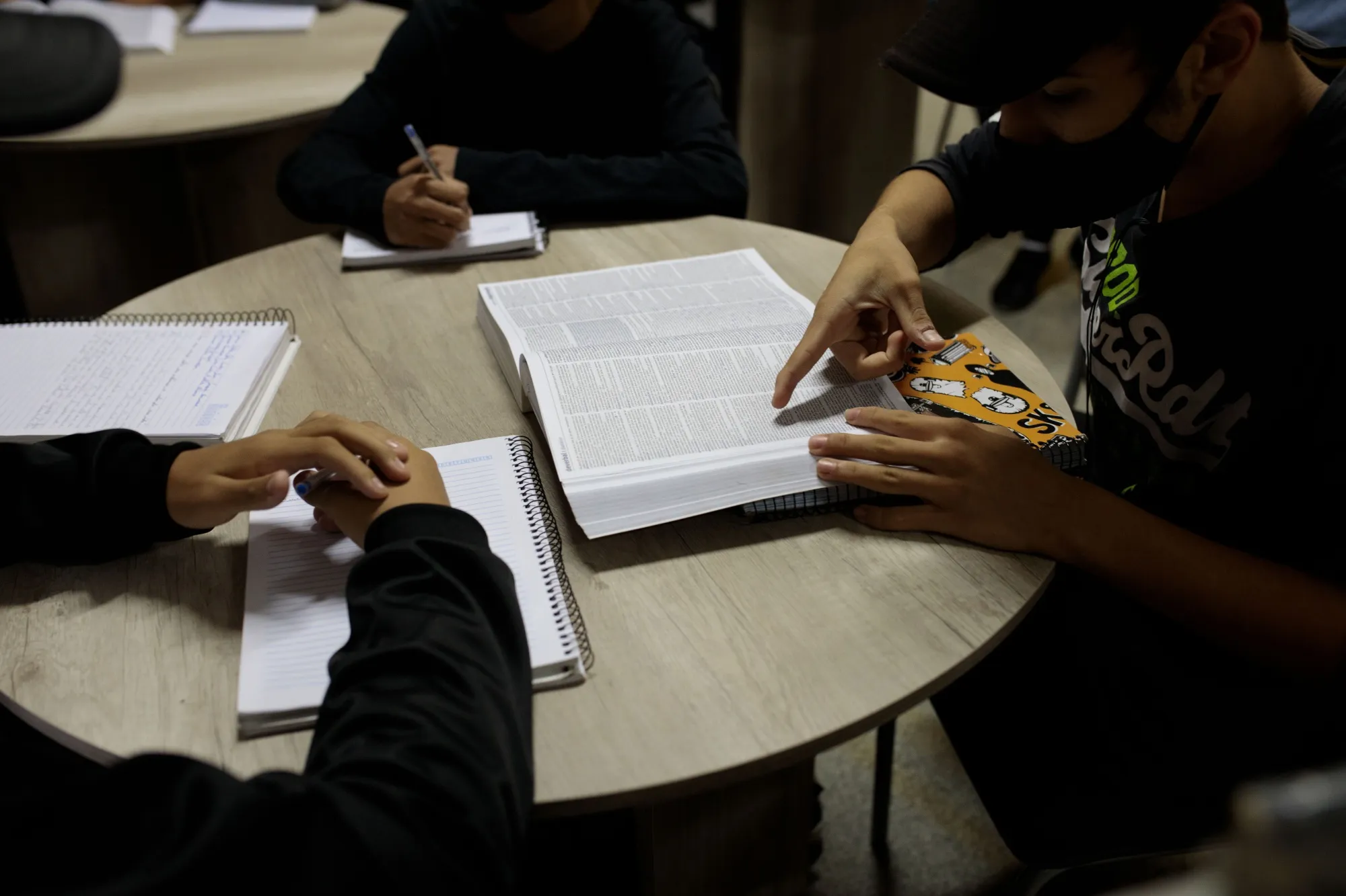 Students attend a class in the library during the first day of mandatory return to classes at a public state school in Sao Paulo, Brazil, on Monday, Oct. 18, 2021. Sao Paulo mandated a return to in-person classes even as many Brazilian states recorded a high number of weekly cases among children.