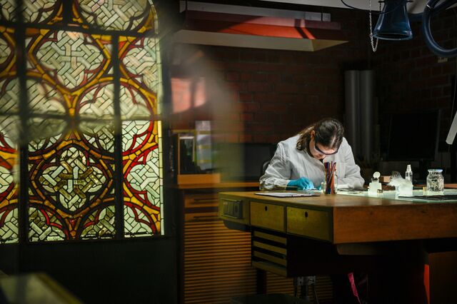 A stained glass restorer works on a window from Notre-Dame at a workshop at Cologne Cathedral.