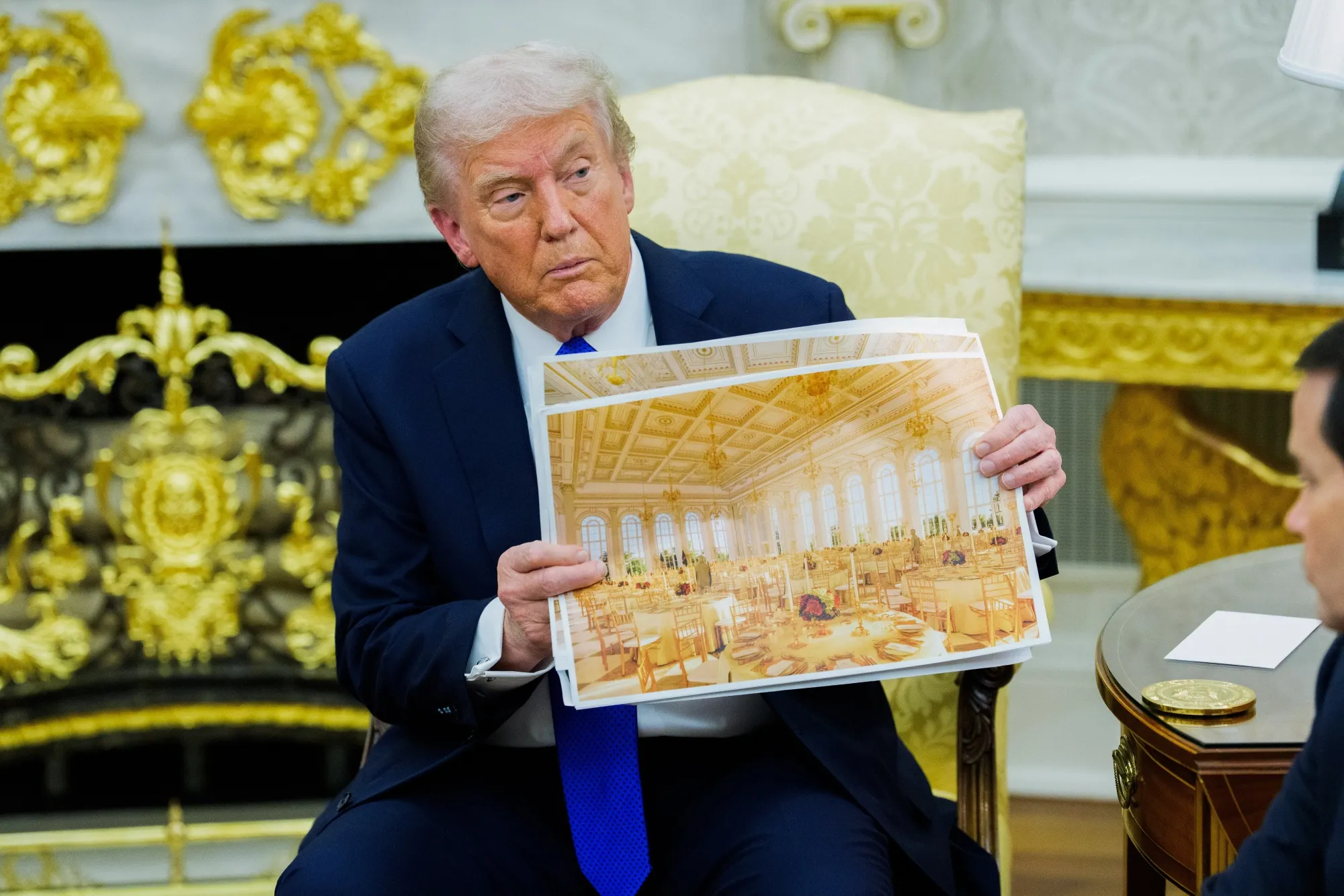 President Donald Trump holds a rendering of the planned White House Ballroom extension in the Oval Office of the White House in Washington on Oct. 22.
