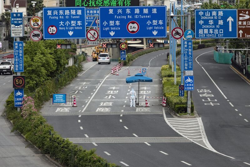 A police officer in personal protective equipment&nbsp;stands guard at a checkpoint during a lockdown due to Covid-19 in Shanghai, China, on May 16.