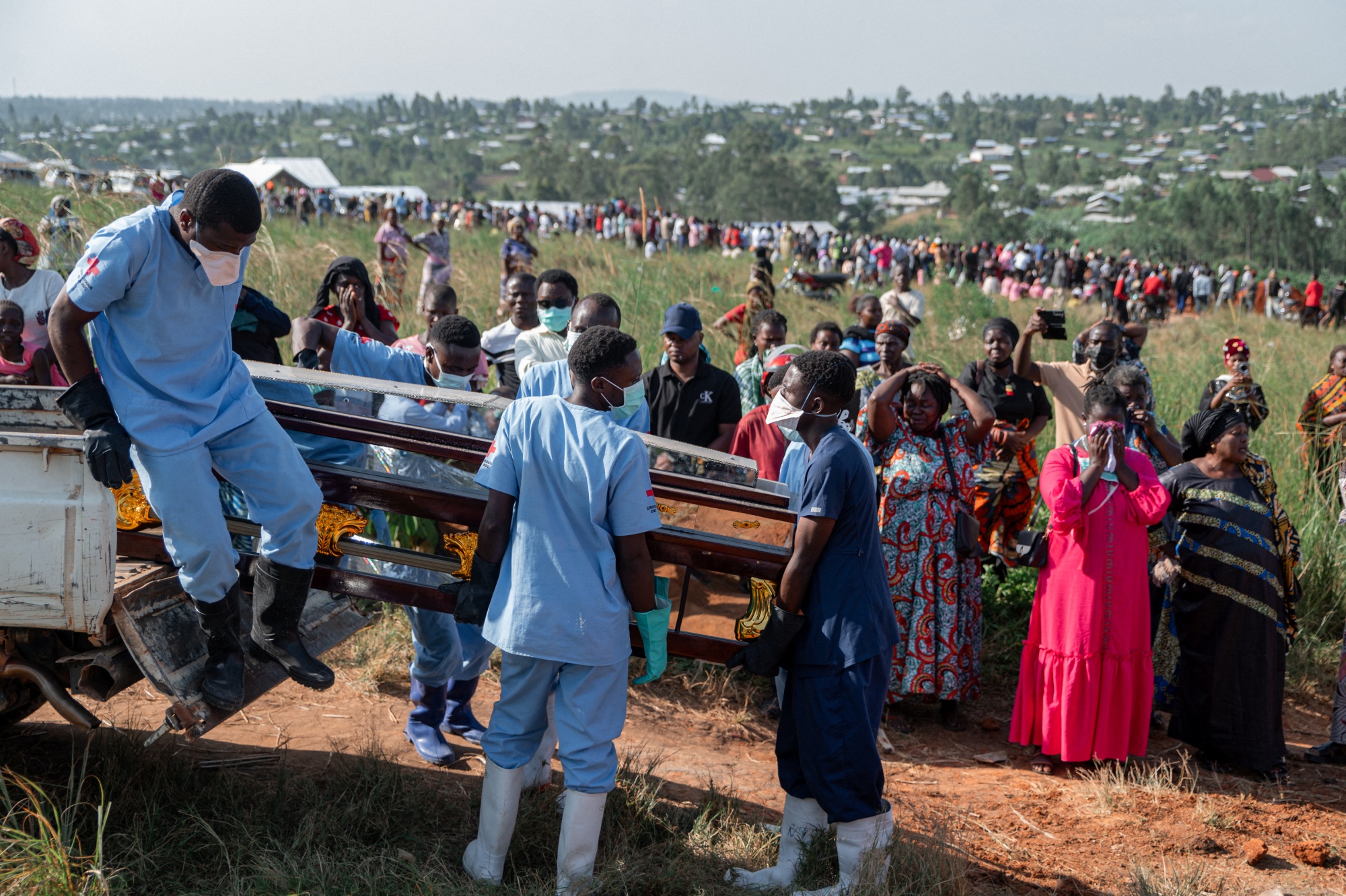 Family members cry upon the arrival of the casket containing the body of a relative who died from Ebola in Congo in June.