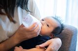 Baby boy drinking milk from a bottle
