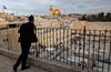 A Jewish man looks out at the Western Wall (bottom-R) and the Dome of the Rock (C) in the Al-Aqsa mosque compound (background)