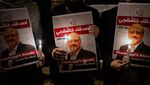 People hold posters picturing Khashoggi and lightened candles during a gathering outside the Saudi Arabia consulate in Istanbul on Oct. 25.