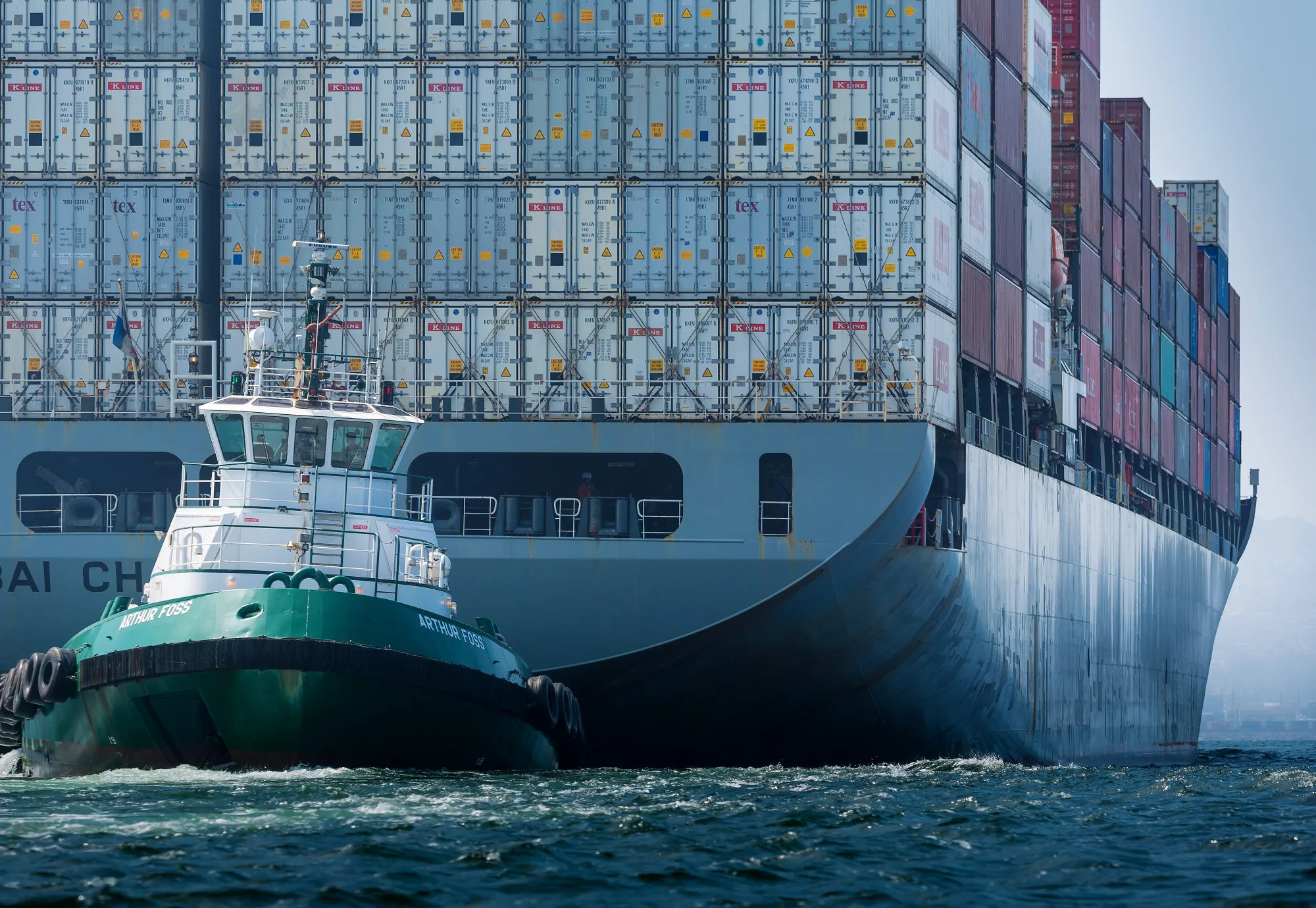 A tugboat guides a cargo ship into the Port of Long Beach in&nbsp;California.