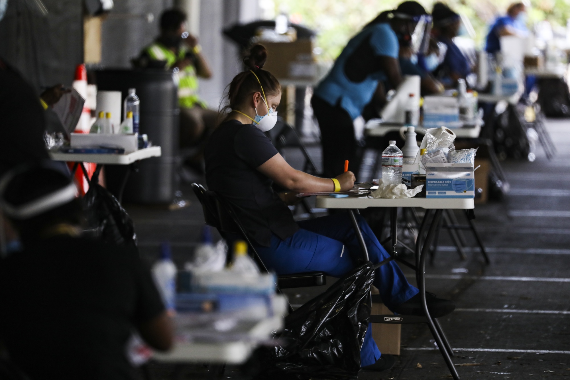 Healthcare workers register people at a Covid-19 testing site in a&nbsp;parking garage&nbsp;in St. Petersburg, Florida on July 14.