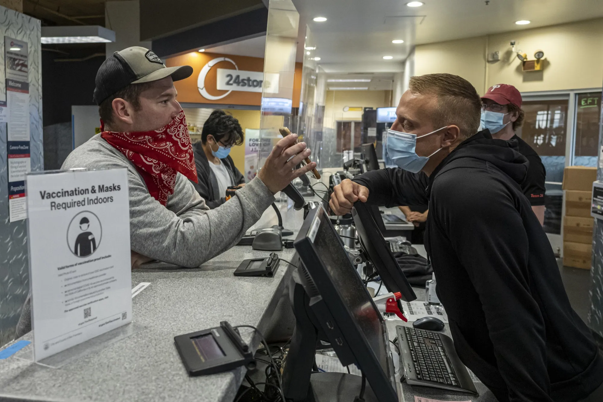 An employee checks the vaccination record of a customer at a 24 Hour Fitness gym in San Francisco on Aug. 20. San Francisco has become the first major U.S. city to require proof of full vaccination against Covid-19 for a variety of high-risk indoor activities.