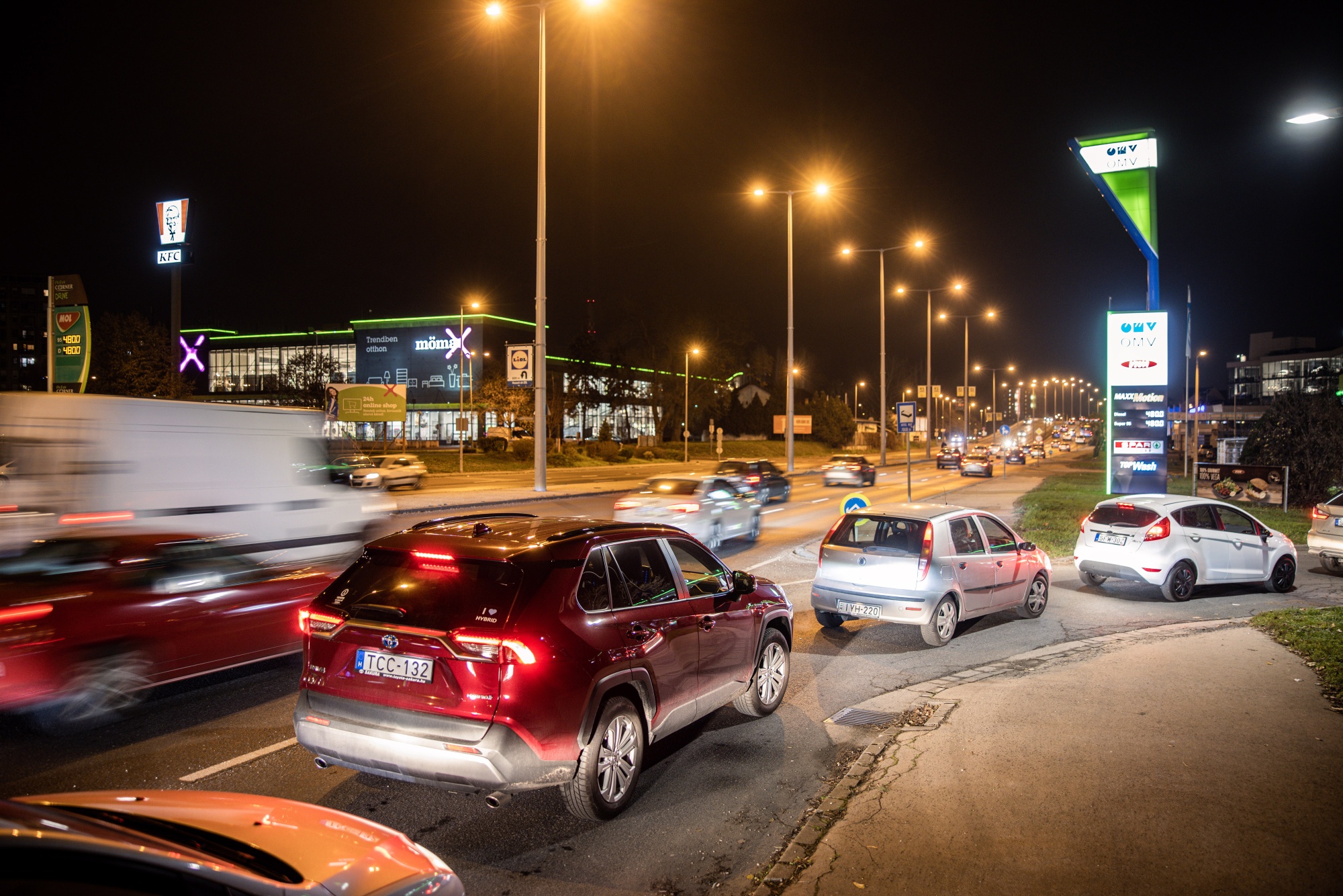 Drivers waiting in line for fuel at an OMV AG station in Budapest.