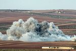 The aftermath of an airstrike near the besieged city of Kobani, close to the Turkish border, on Oct. 15