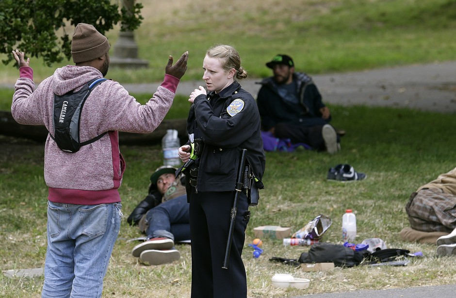 San Francisco Police Officer Kathleen Cavanaugh talks to a man after an incident while patrolling Golden Gate Park in San Francisco.